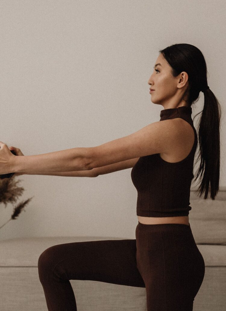 A woman doing a squat exercise in a living room as part of 60 self care ideas for women.